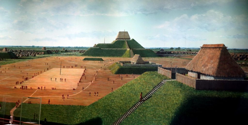 Artystyczna rekonstrukcja miasta Cahokia przedstawiająca plac oraz kopce ziemne z konstrukcjami na szczycie wyk. Prayitno opublikowano na licencji CC BY 2.0, via Wikimedia Commons